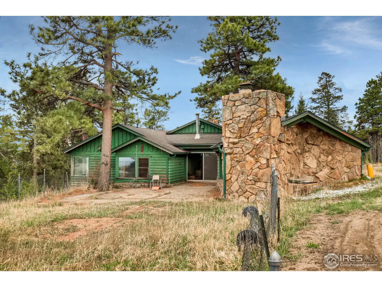 8537 Doubleheader Ranch Road Morrison, CO 80465 - Photo 33 of 40 a front view of a house with garden