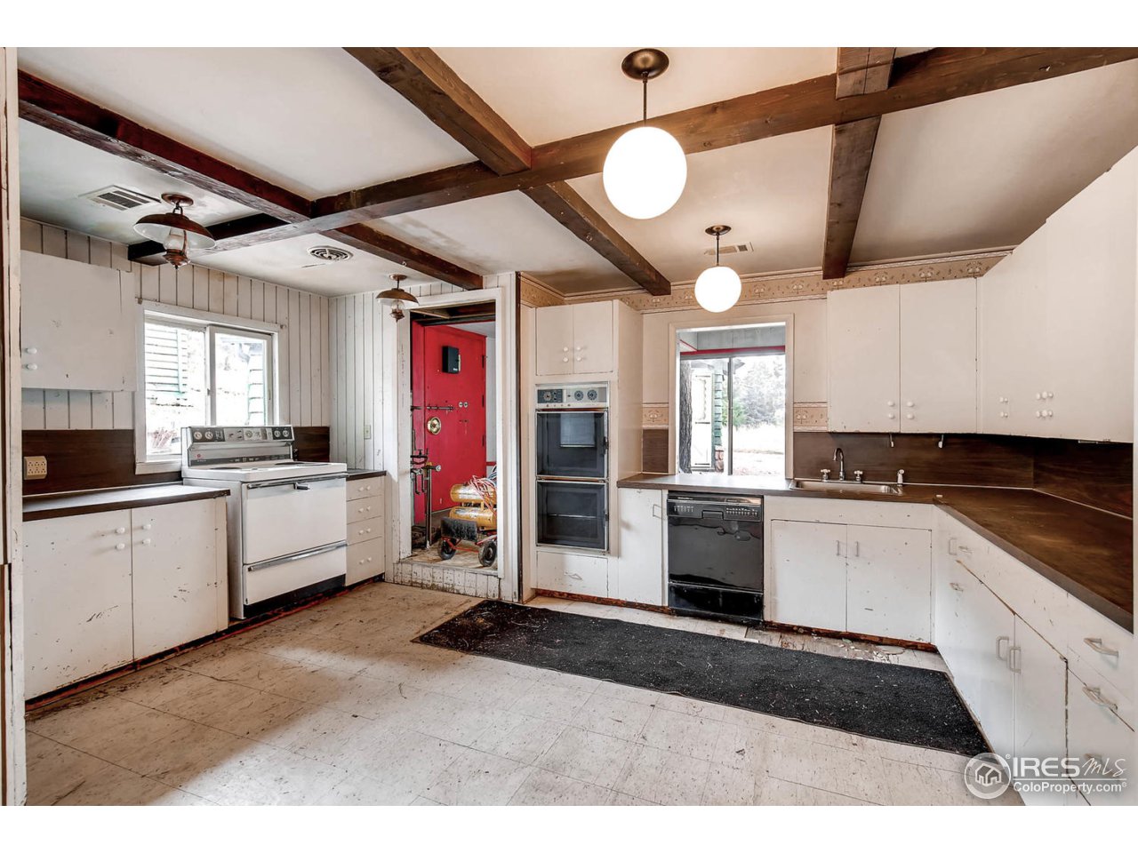 8537 Doubleheader Ranch Road Morrison, CO 80465 - Photo 35 of 40 a kitchen with granite countertop a sink cabinets and stainless steel appliances
