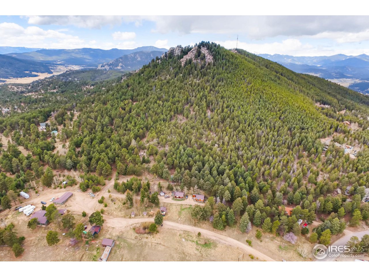 8537 Doubleheader Ranch Road Morrison, CO 80465 - Photo 6 of 40 a view of a field with mountains in the background