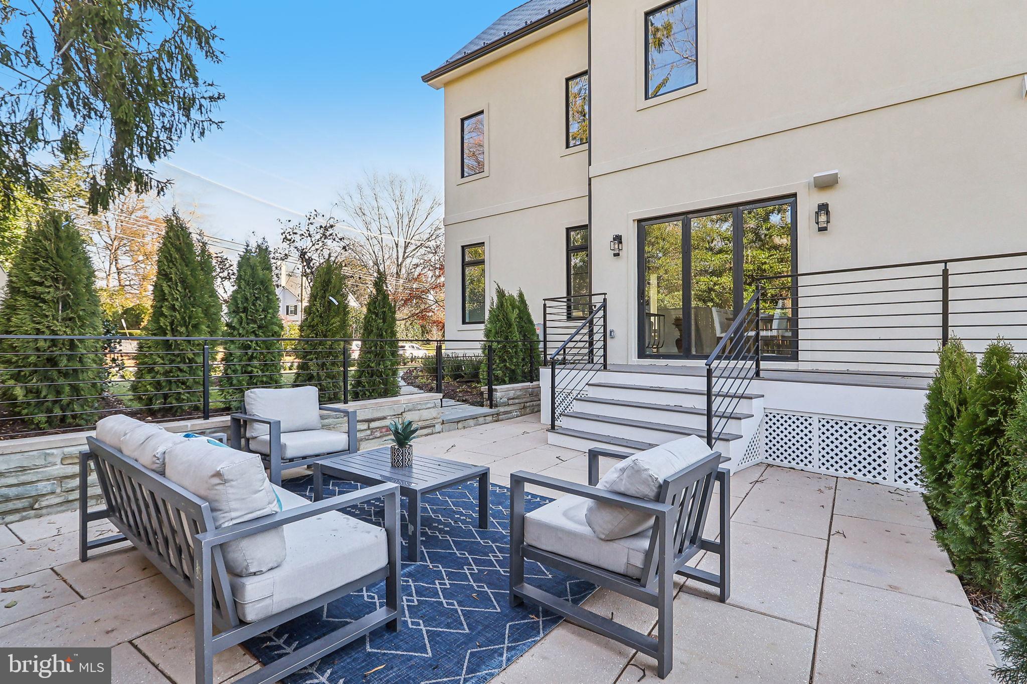 4920 Loughboro Road Northwest Washington, DC 20016 - Photo 11 of 41 a view of a patio with couches table and chairs and potted plants