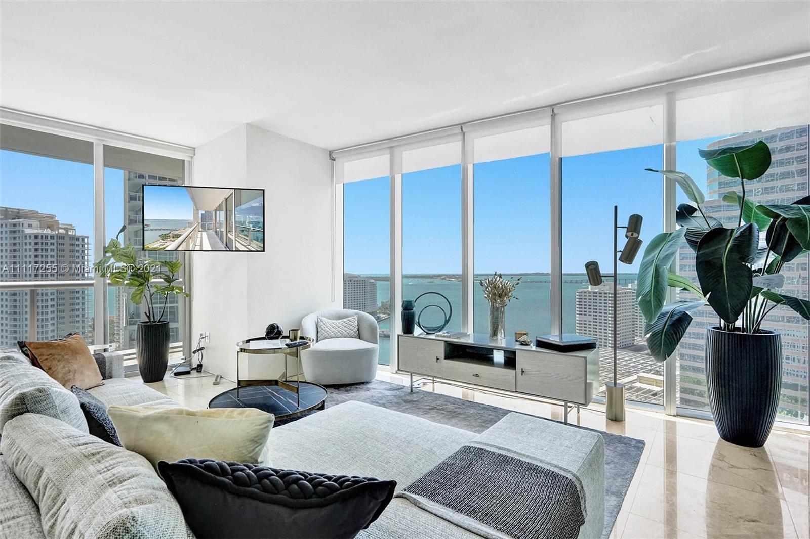 485 Brickell Avenue, Unit 2410 Miami, FL 33131 - Photo 1 of 23 a living room with furniture and a potted plant