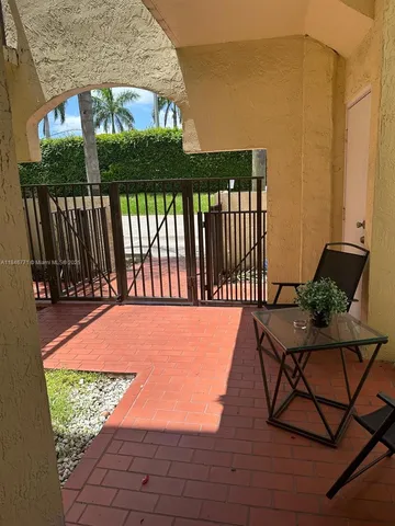 a view of a chairs and table in the patio