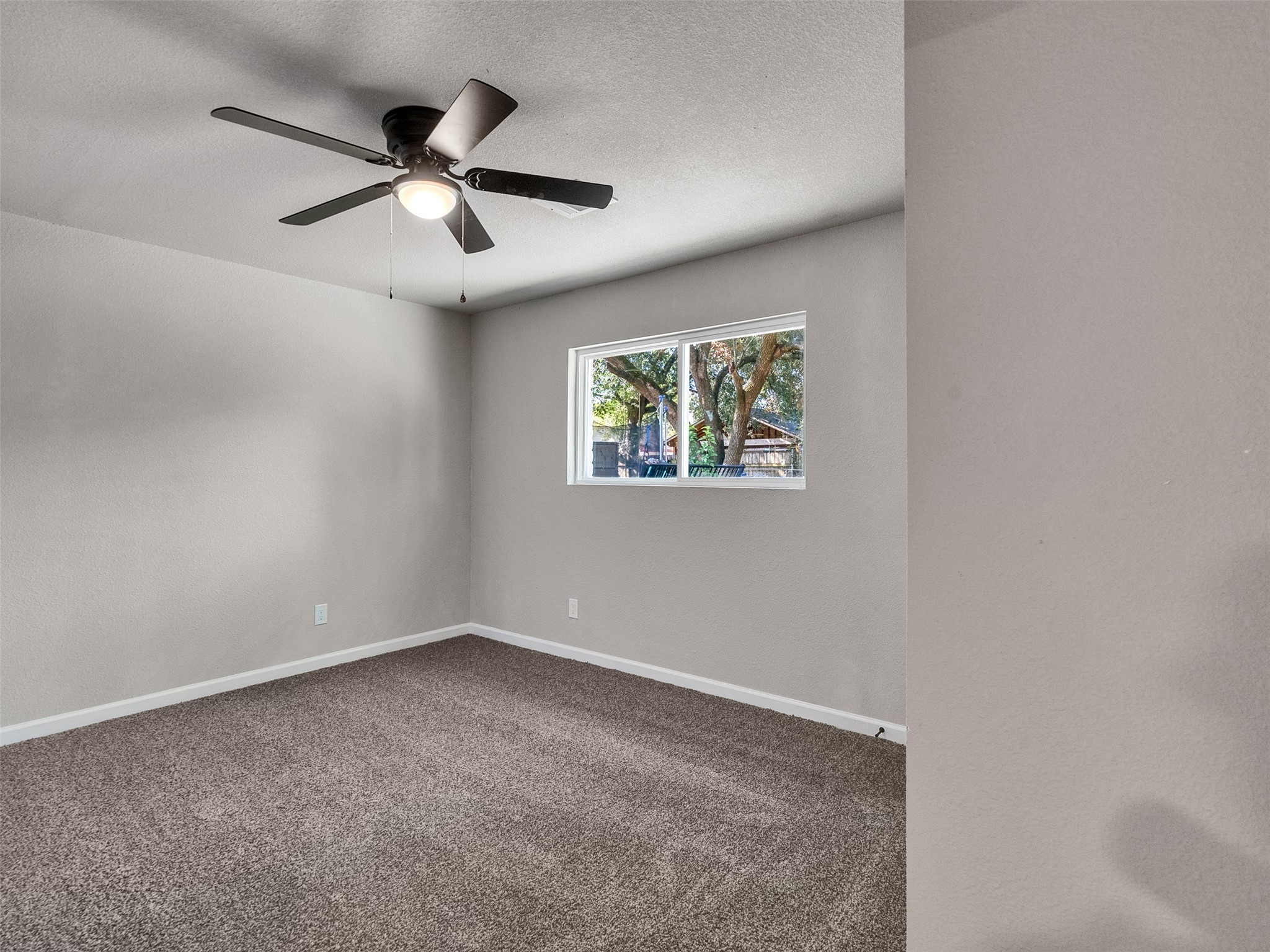 15123 Kaler Road Houston, TX 77060 - Photo 11 of 19 an empty room with windows and fan