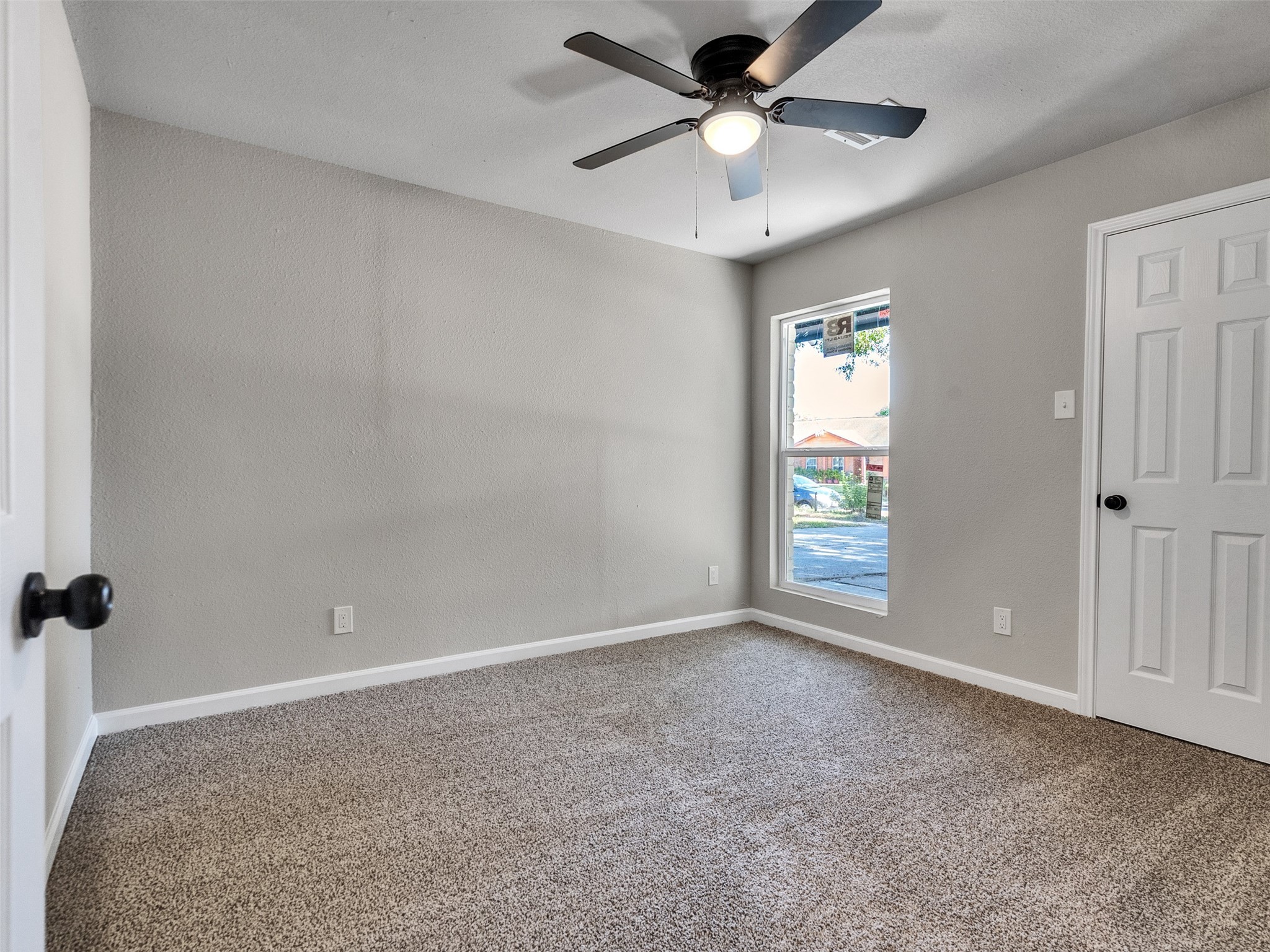 15123 Kaler Road Houston, TX 77060 - Photo 15 of 19 an empty room with windows and fan