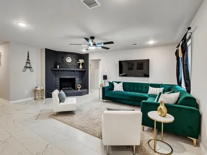 a living room with furniture a fireplace and a flat screen tv