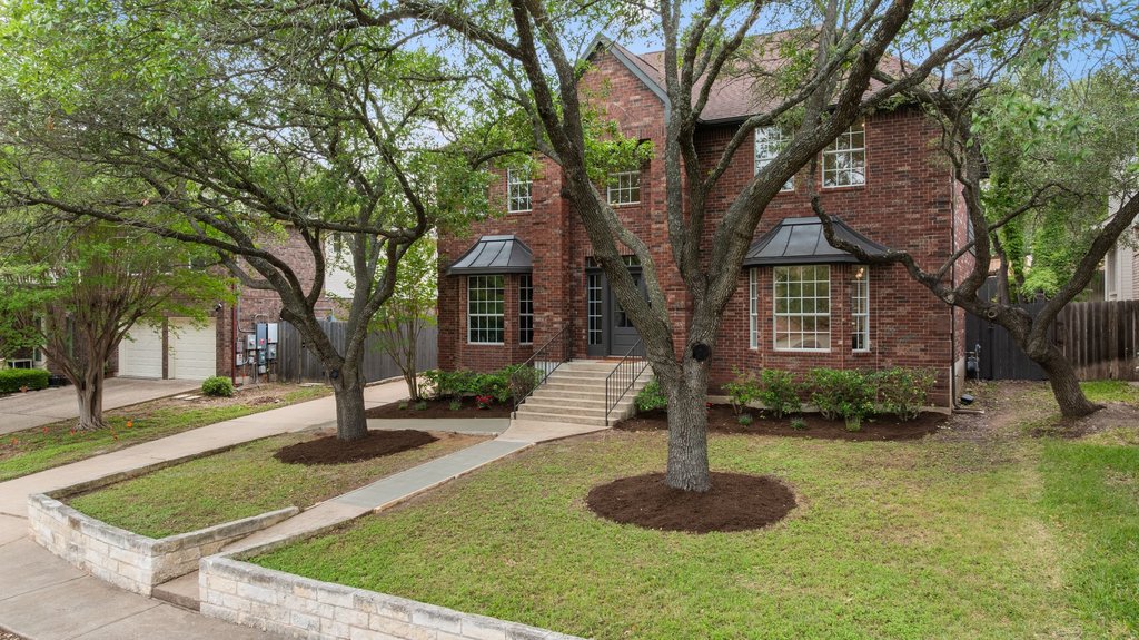 a front view of a house with a yard