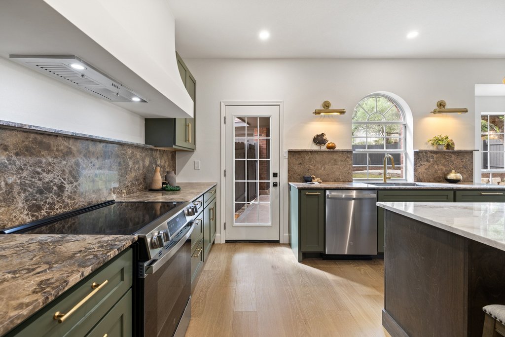 7516 Orrick Drive Austin, TX 78749 - Photo 20 of 40 a kitchen with granite countertop a stove and a sink