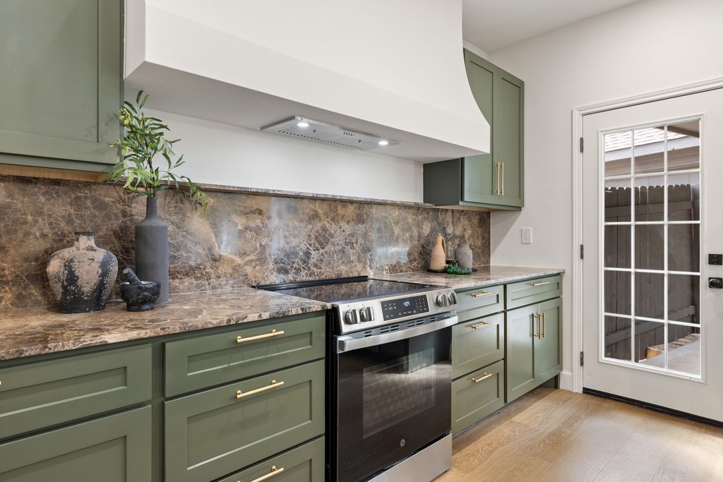 7516 Orrick Drive Austin, TX 78749 - Photo 21 of 40 a kitchen with stainless steel appliances granite countertop a stove and a sink