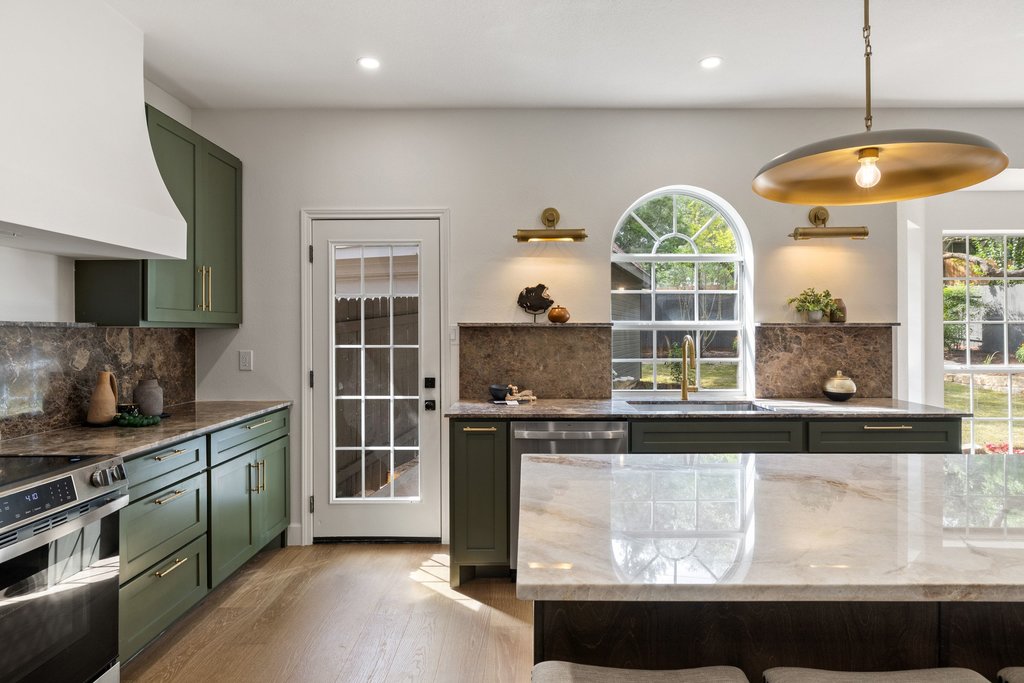 7516 Orrick Drive Austin, TX 78749 - Photo 22 of 40 a kitchen with stainless steel appliances granite countertop a stove and a sink