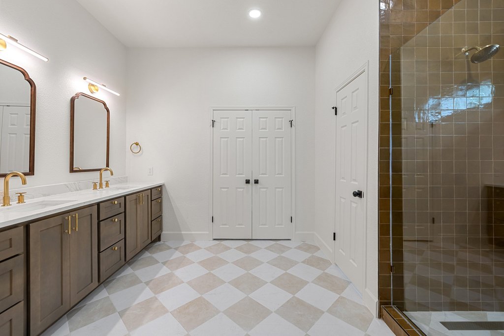 7516 Orrick Drive Austin, TX 78749 - Photo 28 of 40 a spacious bathroom with a double vanity sink mirror and shower