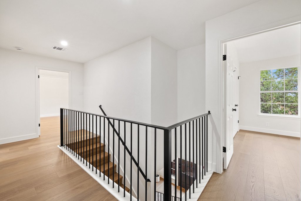 7516 Orrick Drive Austin, TX 78749 - Photo 32 of 40 a view of a hallway with wooden floor and windows