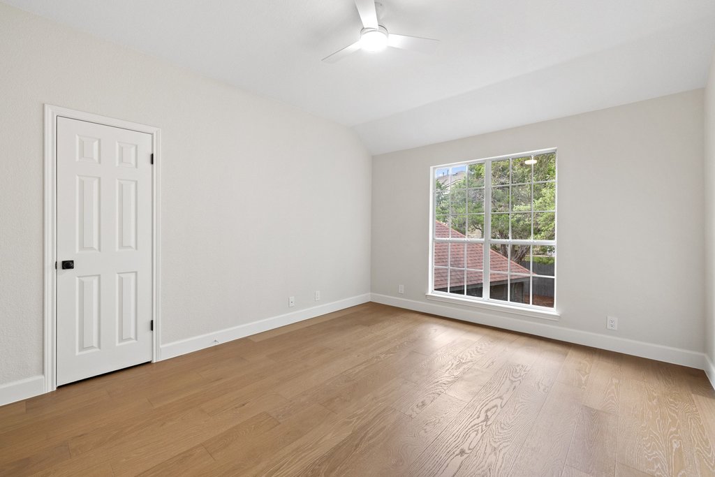 7516 Orrick Drive Austin, TX 78749 - Photo 33 of 40 an empty room with wooden floor and windows