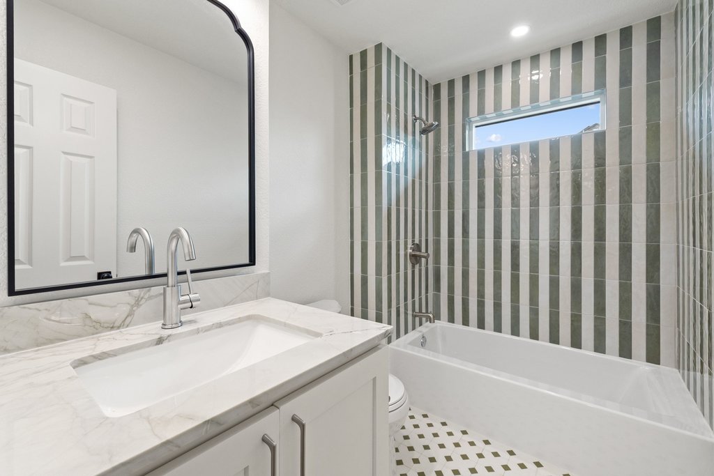 7516 Orrick Drive Austin, TX 78749 - Photo 34 of 40 a bathroom with a granite countertop sink and a mirror