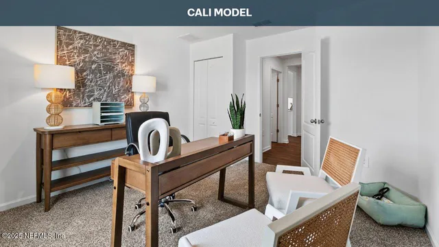 a view of a workspace room with couch and a potted plant