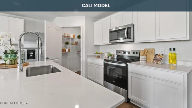 a kitchen with granite countertop a sink and stainless steel appliances