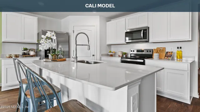 a kitchen with stainless steel appliances granite countertop a sink a microwave and cabinets