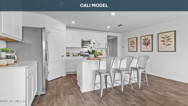 a view of kitchen with cabinets and wooden floor