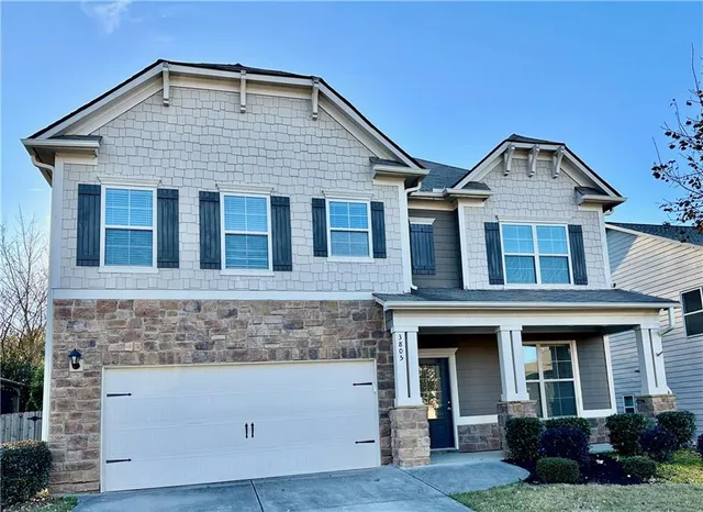 a front view of a house with garden