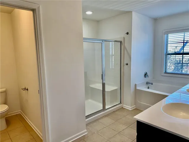 a view of a room with wooden floor and a window