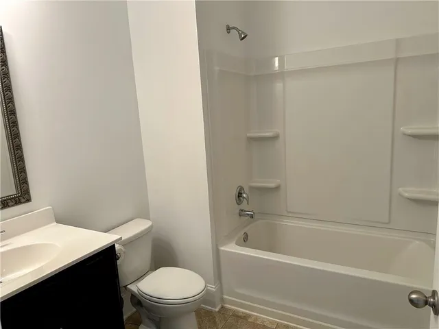 a bathroom with a bathtub and a toilet