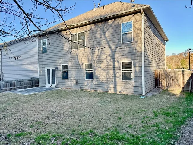 a view of a house with pool and sitting area
