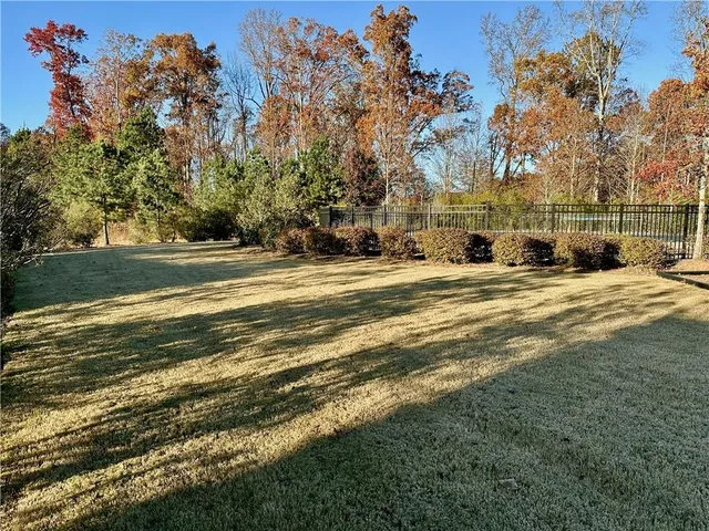 a view of a swimming pool with an outdoor seating and a yard