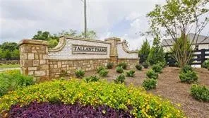 an aerial view of a house with a yard and lake view