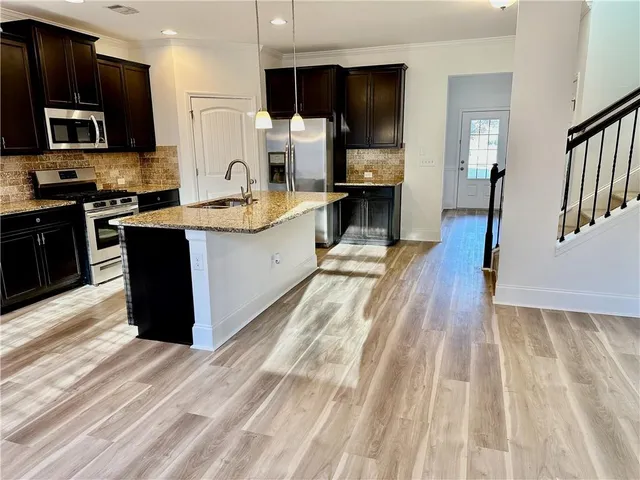 a view of empty room with wooden floor and fireplace