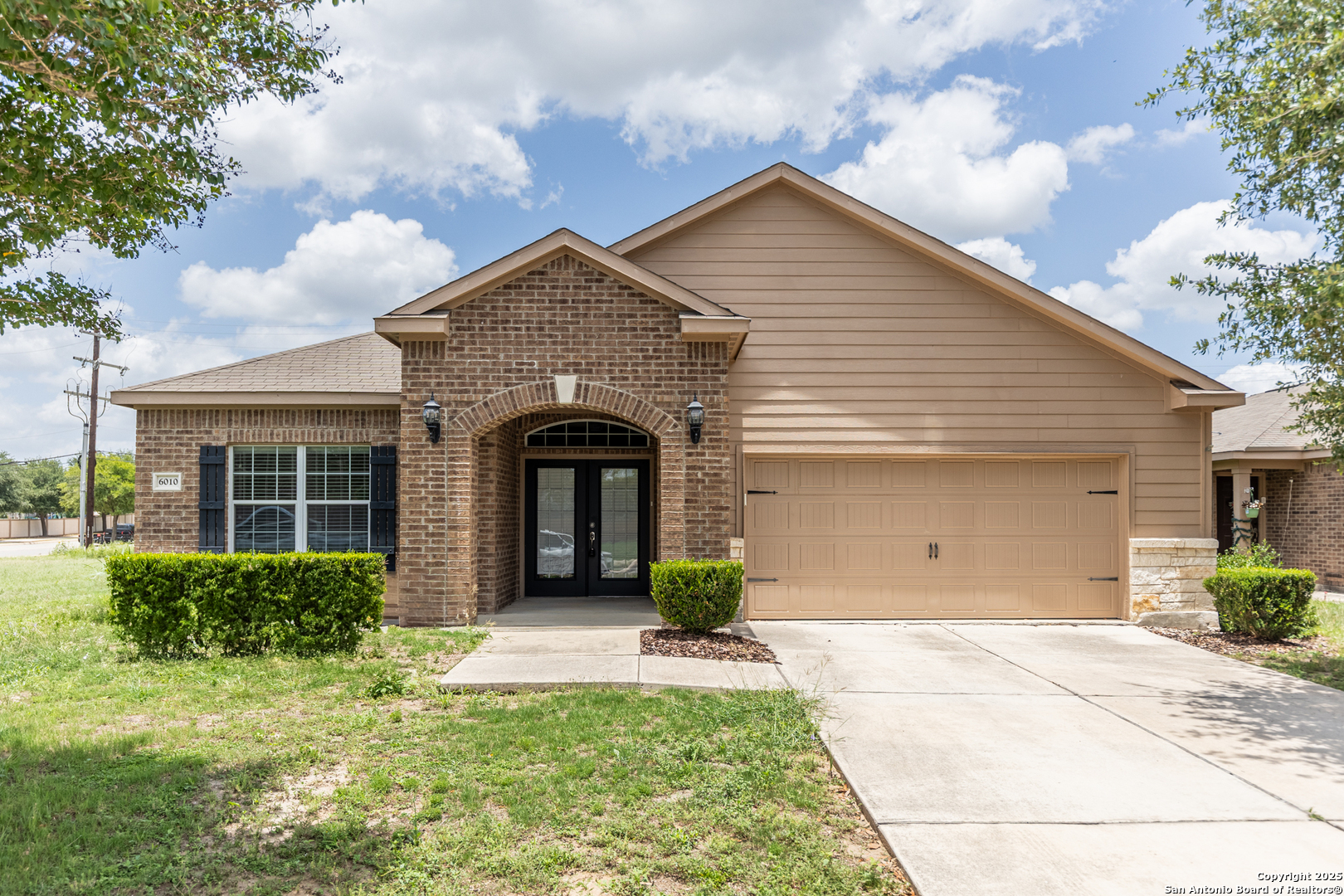 a view of house with backyard and garden