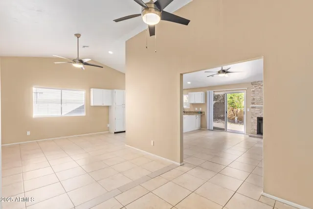 a view of a livingroom with a ceiling fan and window