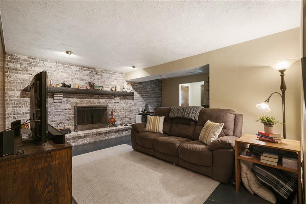 170 Ralston Road Sarver, PA 16055 - Photo 19 of 28 a living room with furniture a fireplace and a flat screen tv