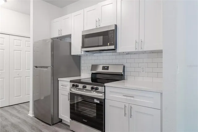 a kitchen with a sink cabinets and wooden floor