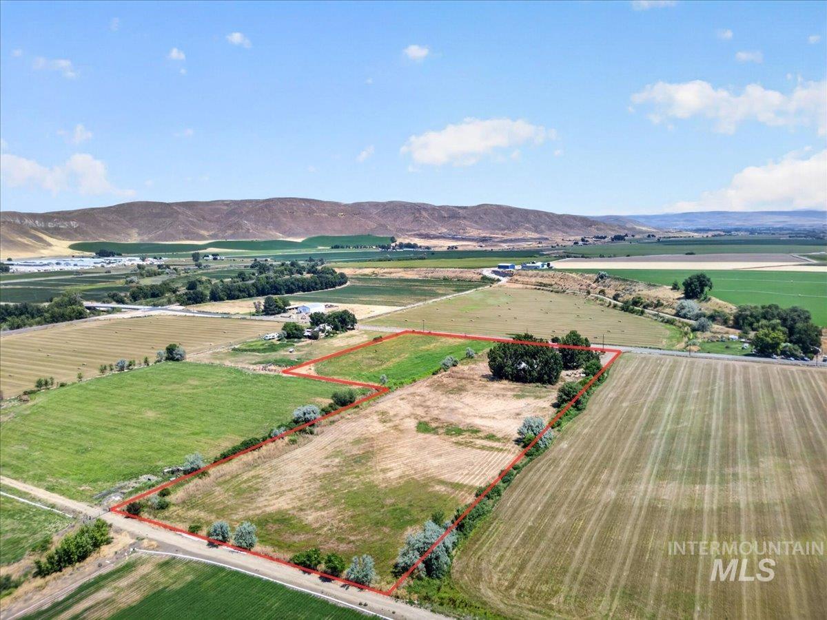 587 Cove Road Weiser, ID 83672 - Photo 23 of 30 Expansive rural property featuring multiple agricultural fields, a distant mountain range backdrop, and mature perimeter trees