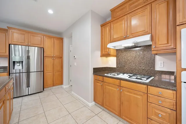a kitchen with granite countertop a stove and cabinets