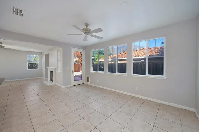 a kitchen with stainless steel appliances granite countertop a refrigerator and a stove top oven with white cabinets