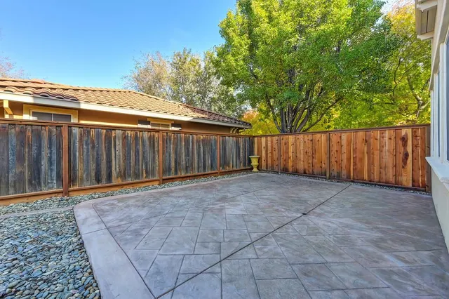 a view of a park with furniture and wooden fence