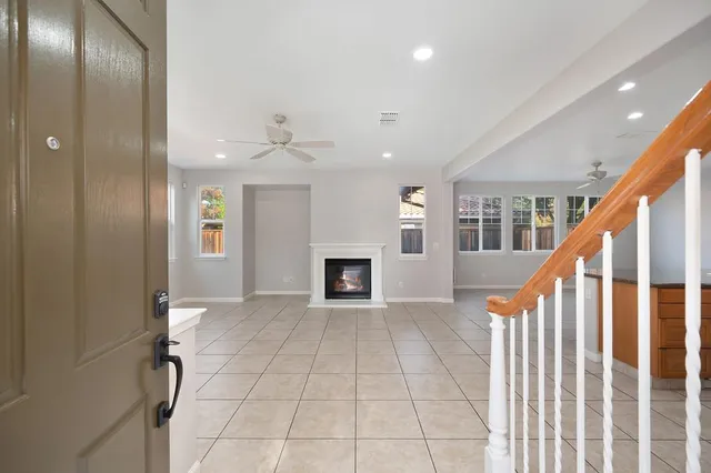 a view of an empty room with a fireplace and a window