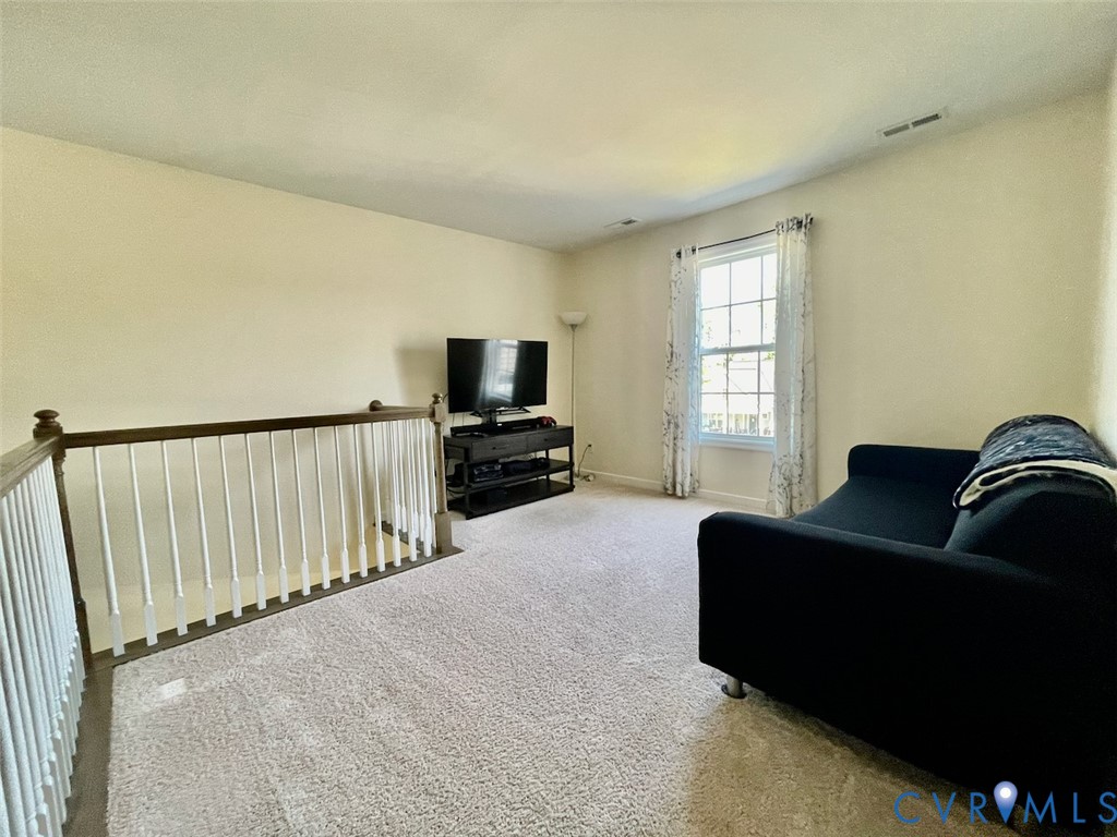 9506 Simonsville Road Midlothian, VA 23112 - Photo 13 of 27 a living room with furniture flat screen tv and a window