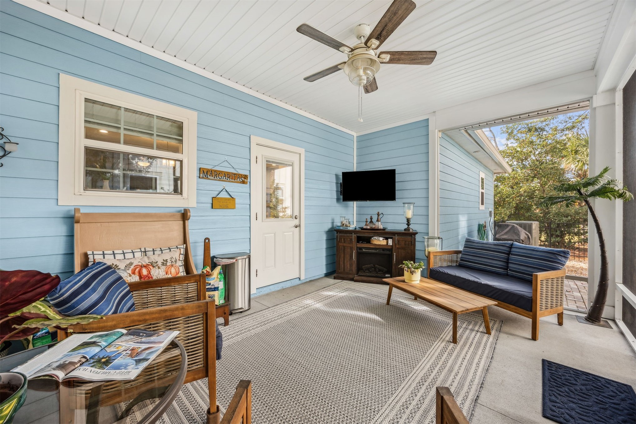 307 Elm Street Fernandina Beach, FL 32034 - Photo 25 of 35 a living room with furniture a fireplace and a flat screen tv