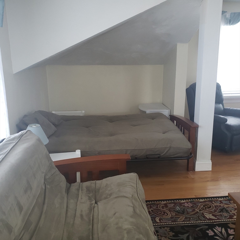 398 North End, Unit B Salisbury, MA 01952 - Photo 7 of 13 a bedroom with a bed and wooden floor