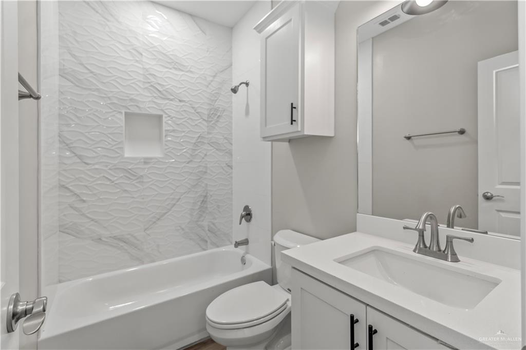 2804 West Israel Avenue, Unit 2 Alton, TX 78573 - Photo 11 of 12 a bathroom with a sink toilet and shower