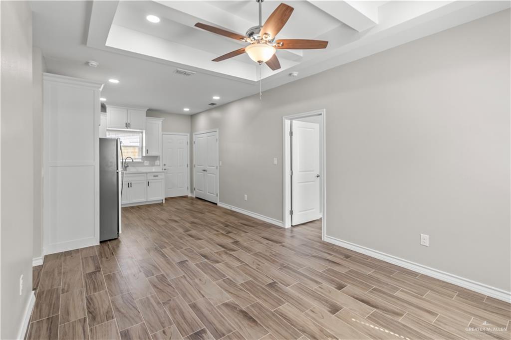 2804 West Israel Avenue, Unit 2 Alton, TX 78573 - Photo 5 of 12 a view of kitchen and empty room with wooden floor