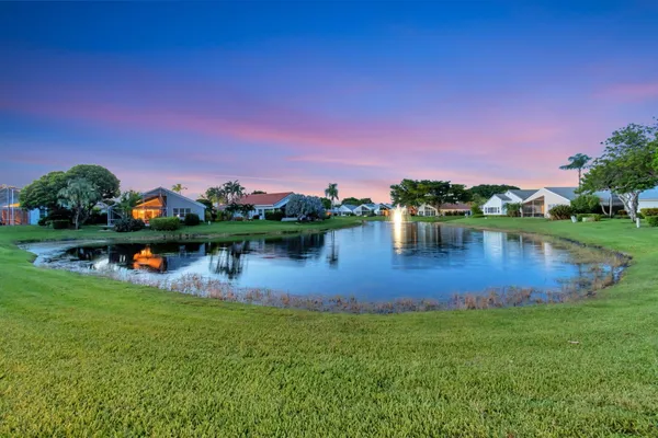 a view of a lake with houses in the back