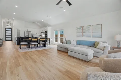 a living room with furniture and kitchen view