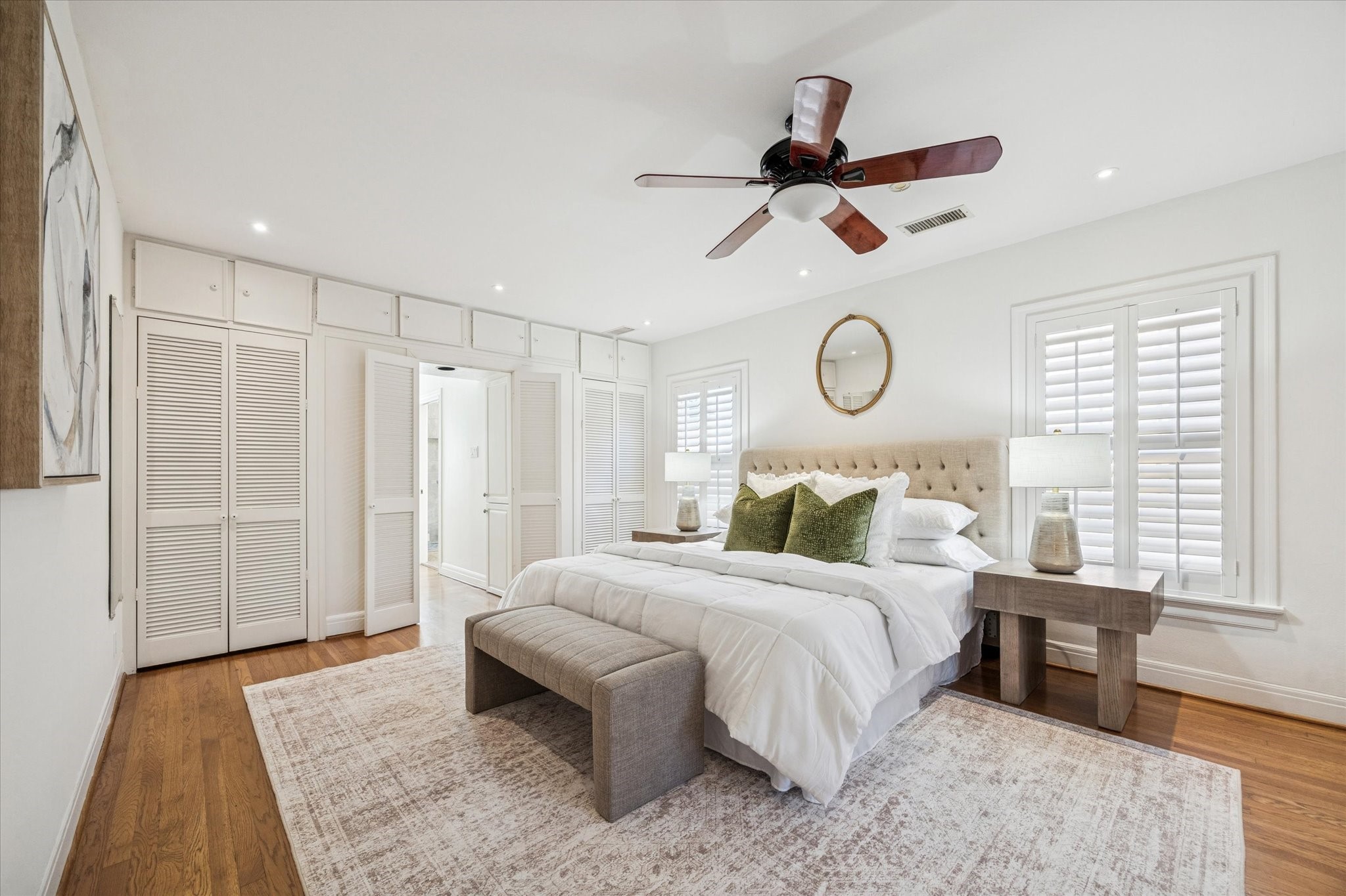 2409 Dryden Road Houston, TX 77030 - Photo 14 of 32 At the top of the stairs, you enter one of two primary bedrooms, offering a private and inviting retreat. Two closets—one of which is cedar-lined—are conveniently located flanking the entry to the bathroom.