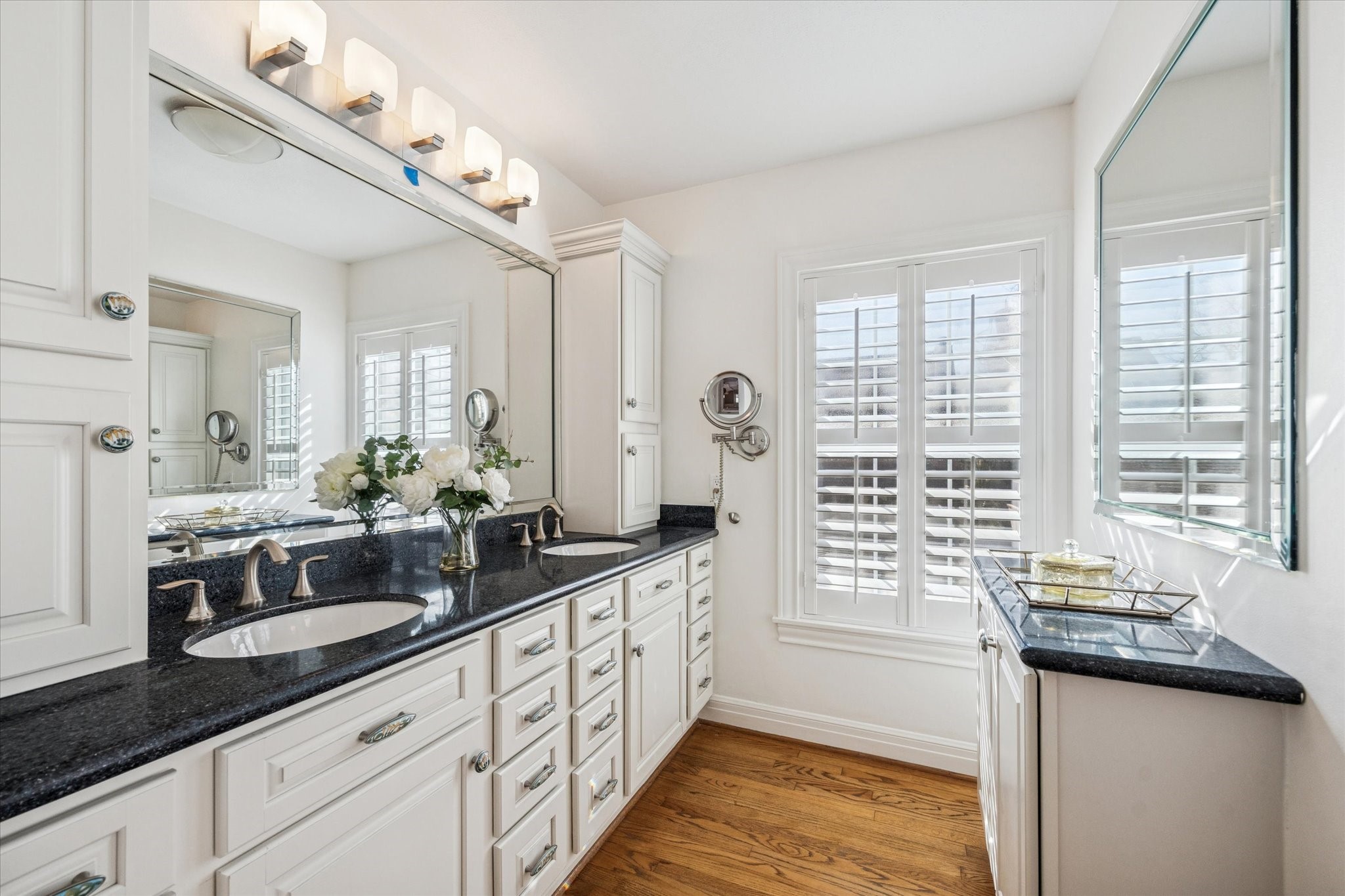 2409 Dryden Road Houston, TX 77030 - Photo 15 of 32 The ensuite bath features double sinks and abundant storage, allowing for an organized and functional daily routine. Well-designed cabinetry offers ample space for linens and essentials, while the layout provides room for two to get ready with ease.