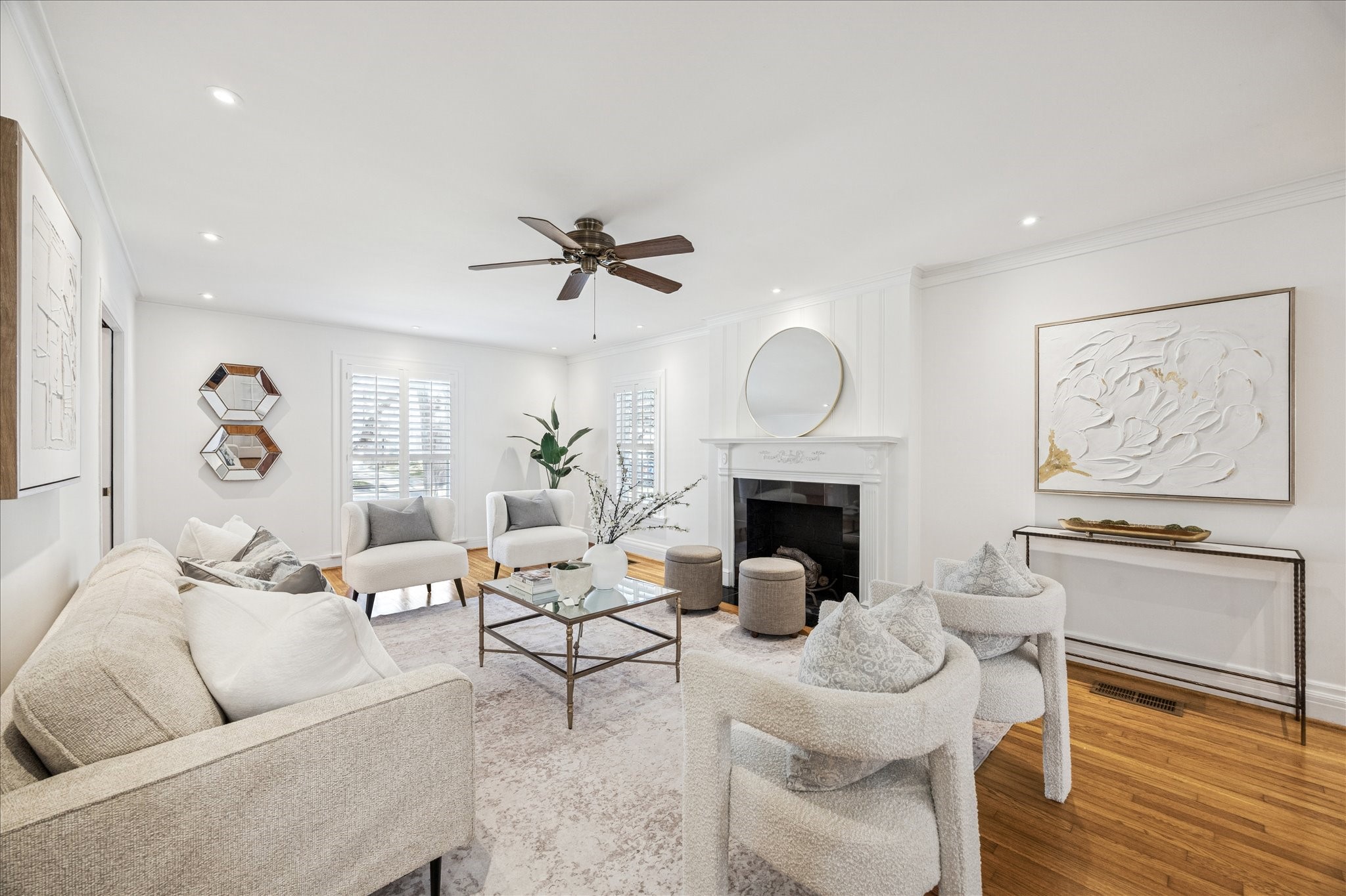 2409 Dryden Road Houston, TX 77030 - Photo 3 of 32 This elegant formal living room is anchored by a gas log fireplace and enhanced by classic plantation shutters and rich hardwood flooring. Recessed lighting adds a warm, inviting glow, while pocket doors to the entry and French doors to the family room create both flow and flexibility.