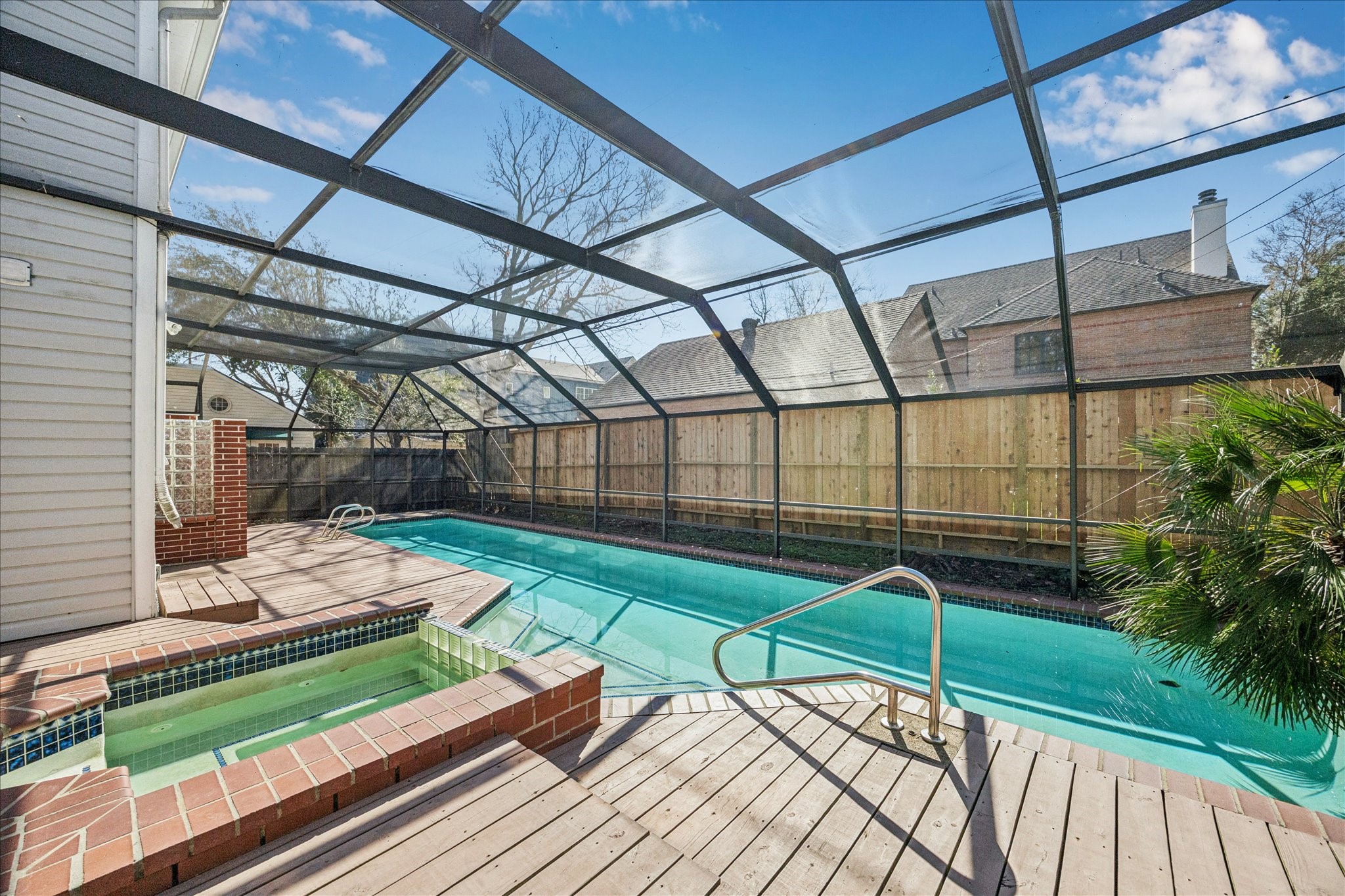 2409 Dryden Road Houston, TX 77030 - Photo 32 of 32 The view overlooks a backyard centered entirely around the pool, creating a clean, resort-like setting with minimal upkeep. This easy-maintenance outdoor space is ideal for enjoying the water, relaxing poolside, and entertaining.