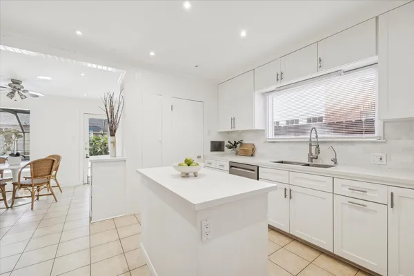 a kitchen with white cabinets and white appliances