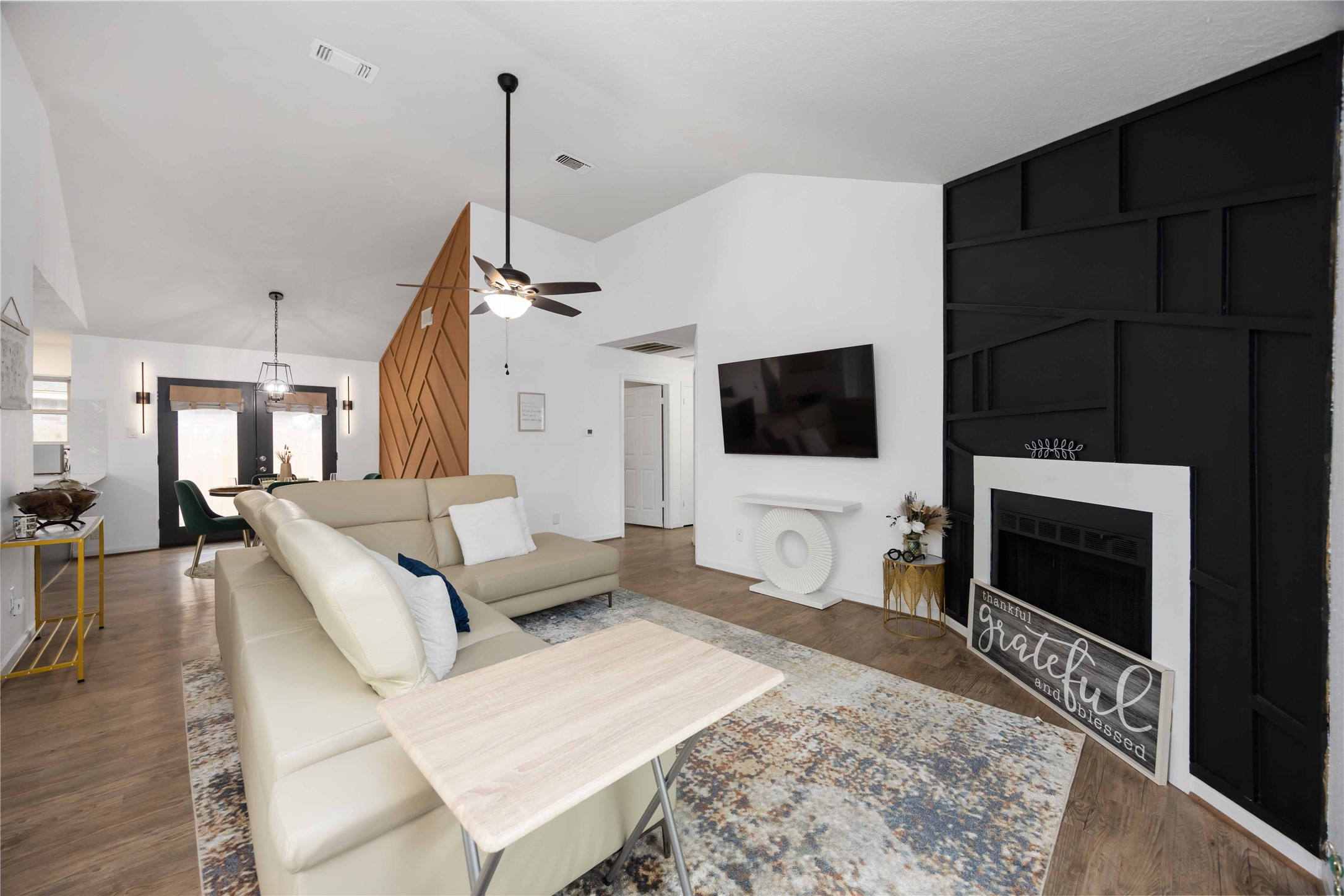 a living room with a flat screen tv and a fireplace
